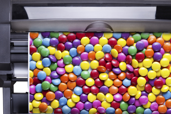 A close up of many colorful candies on the counter.